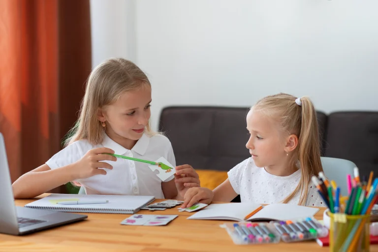little girls doing online school together