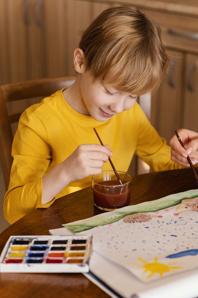 close up kid using watercolors