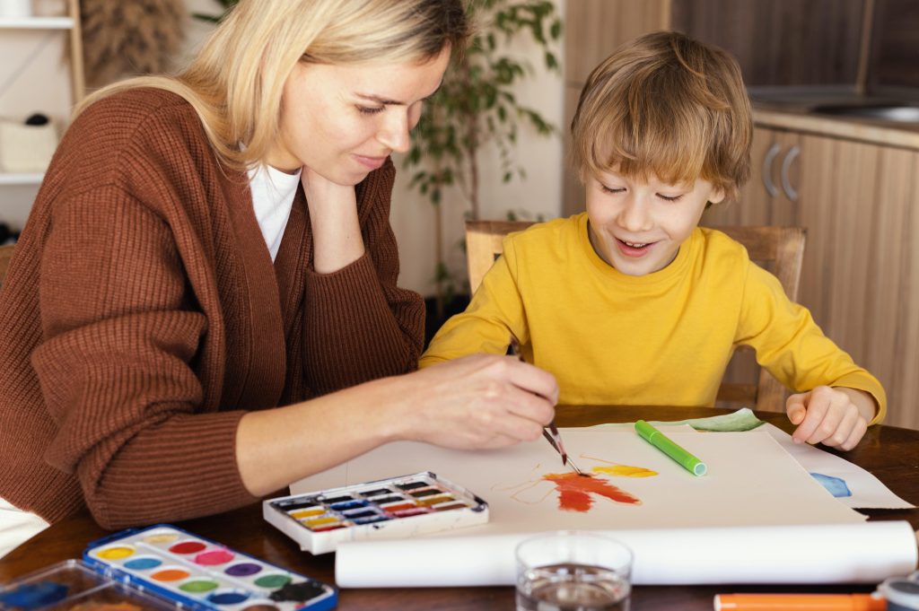 medium shot woman painting paper
