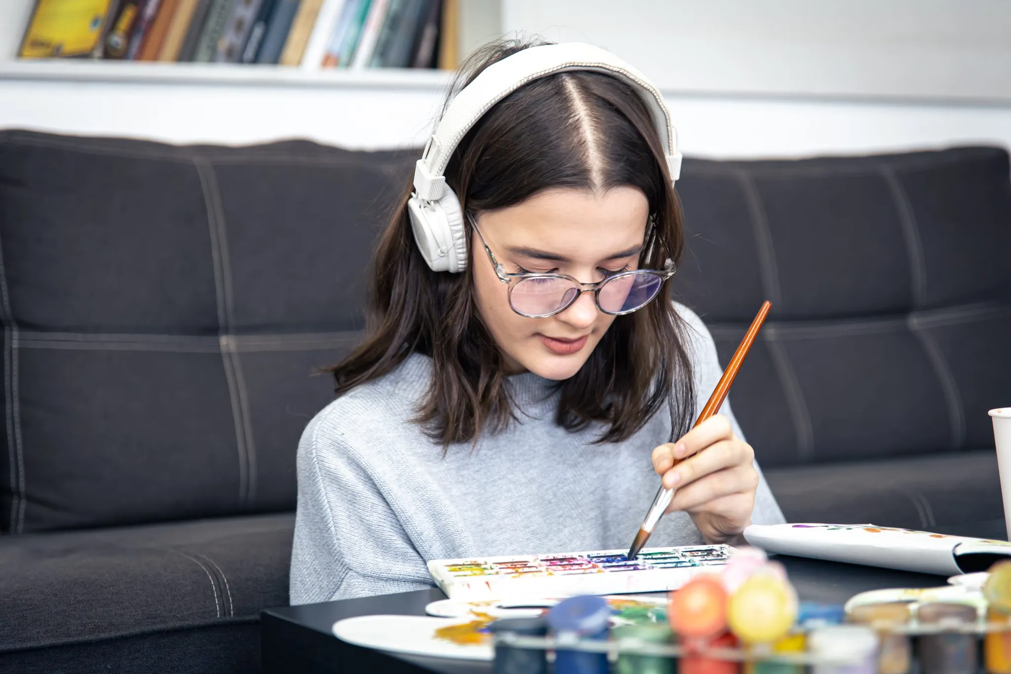 stylish young woman draws with paints home interior 2048x1365 1